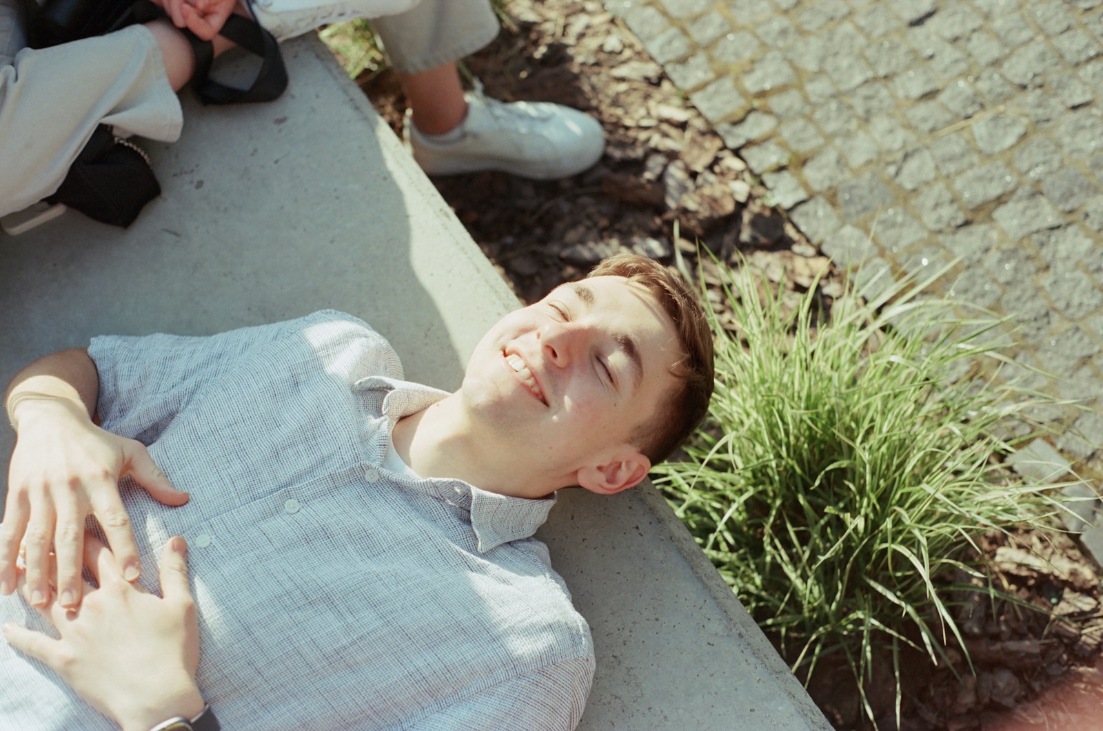 A man laying on the ground next to a woman
