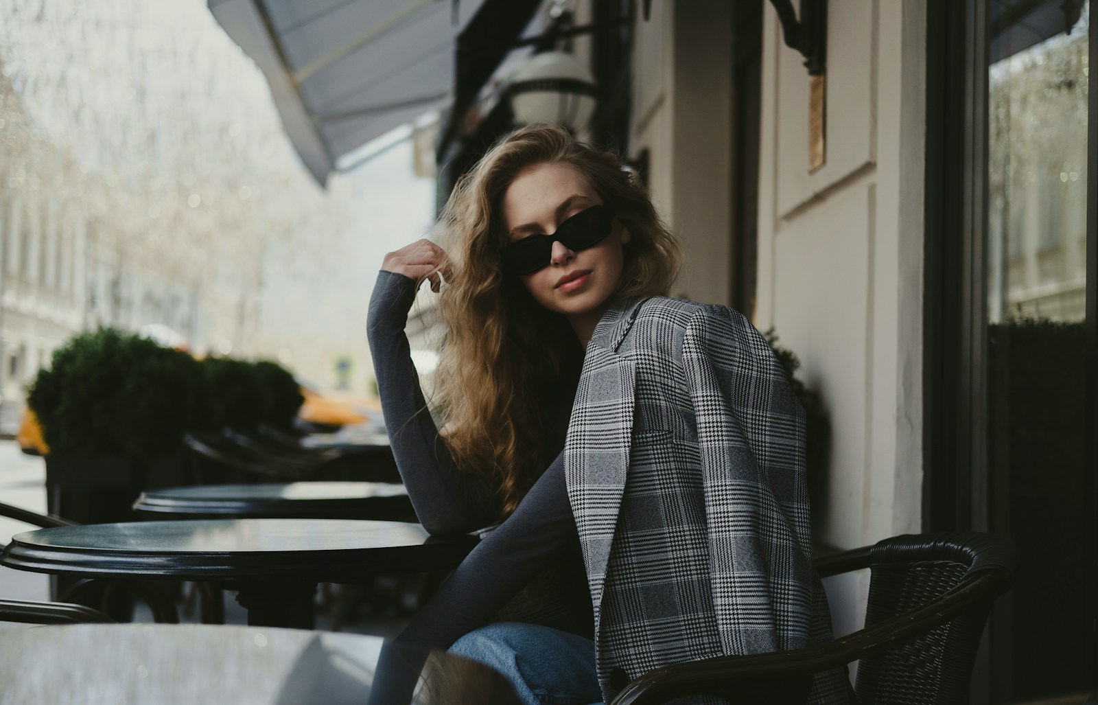 a woman sitting in front of a building