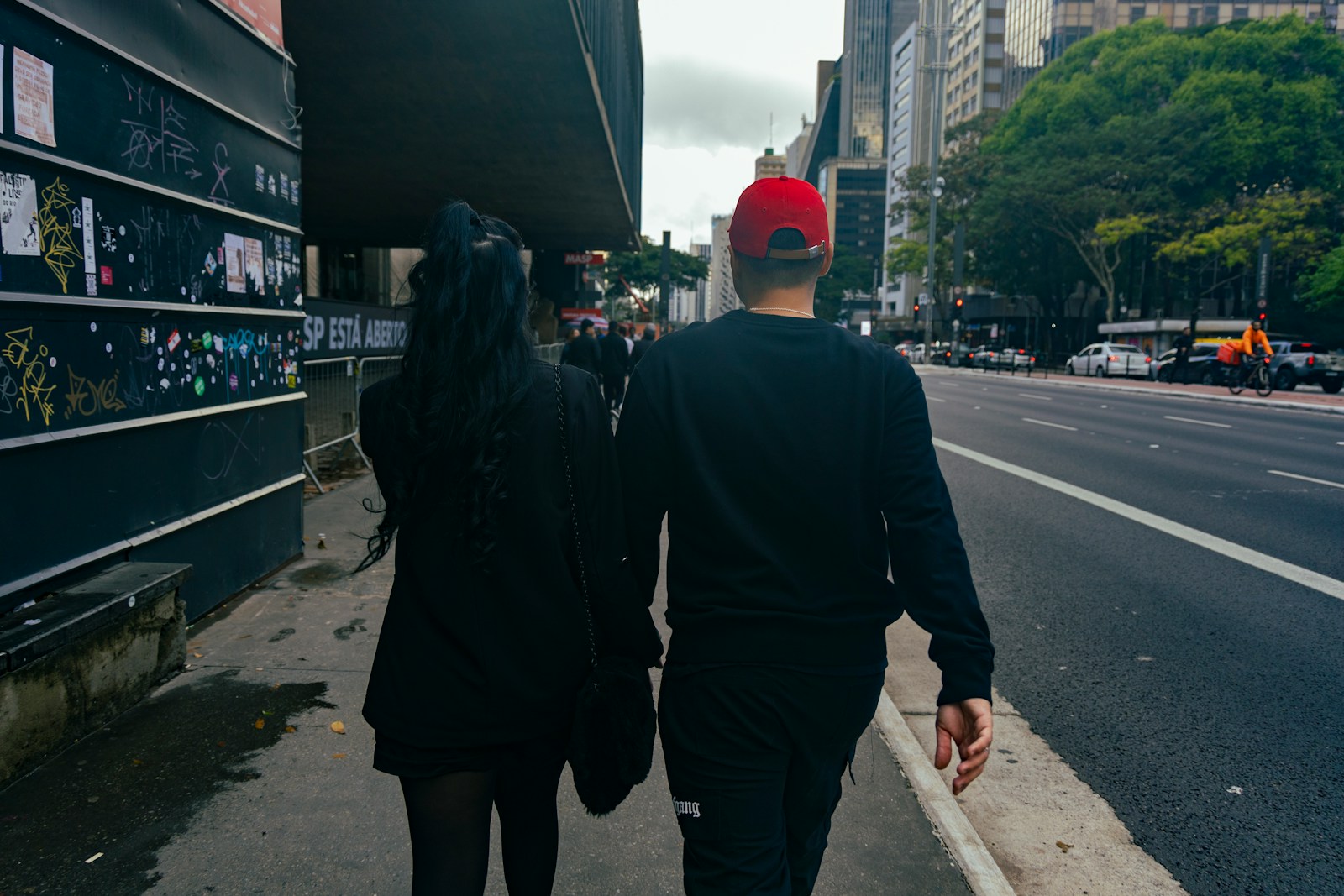 A man and a woman walking down a street