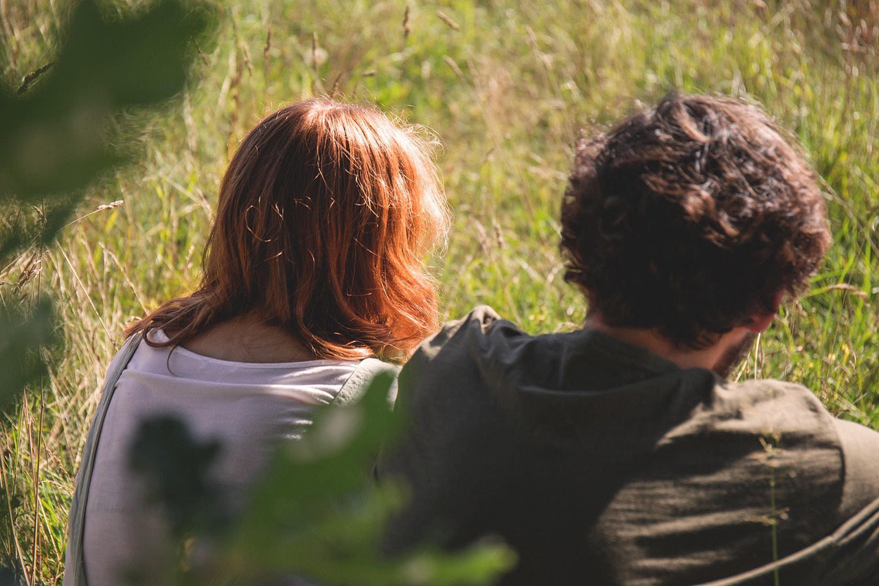 field, girl, grass, man, outdoors, people, sitting, nature, woman
